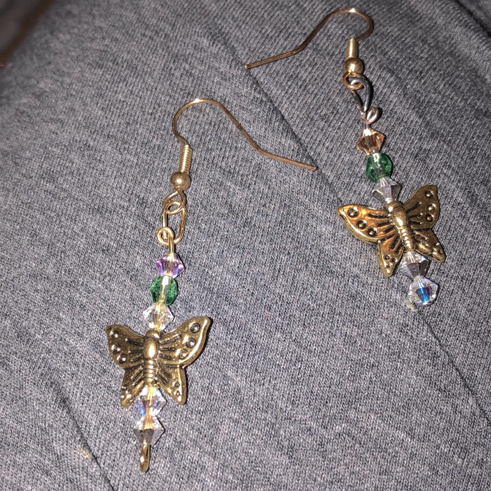 Handmade dangly butterfly earrings with different color beads.
